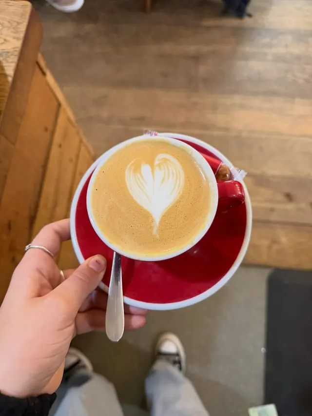 Cappuccino on a red saucer